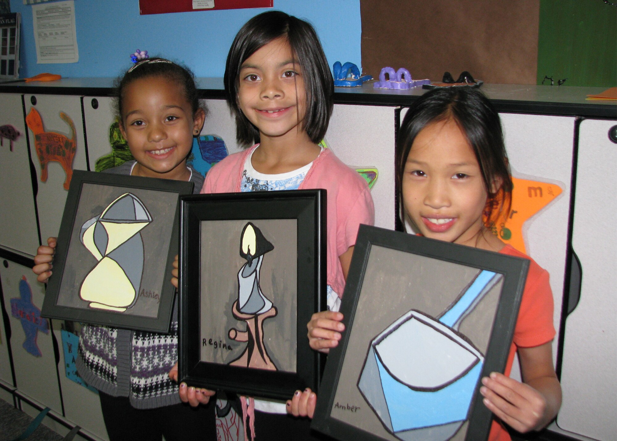 Three of Jacinta Cross's aspiring artists recreate Picasso's “Verre et Pichet” in their arts and crafts after school class at the School Age Annex. From left: Ashley, Regina and Amber. All three young artists are 7-year-old second graders. (Air Force photo by Diane Betzler)