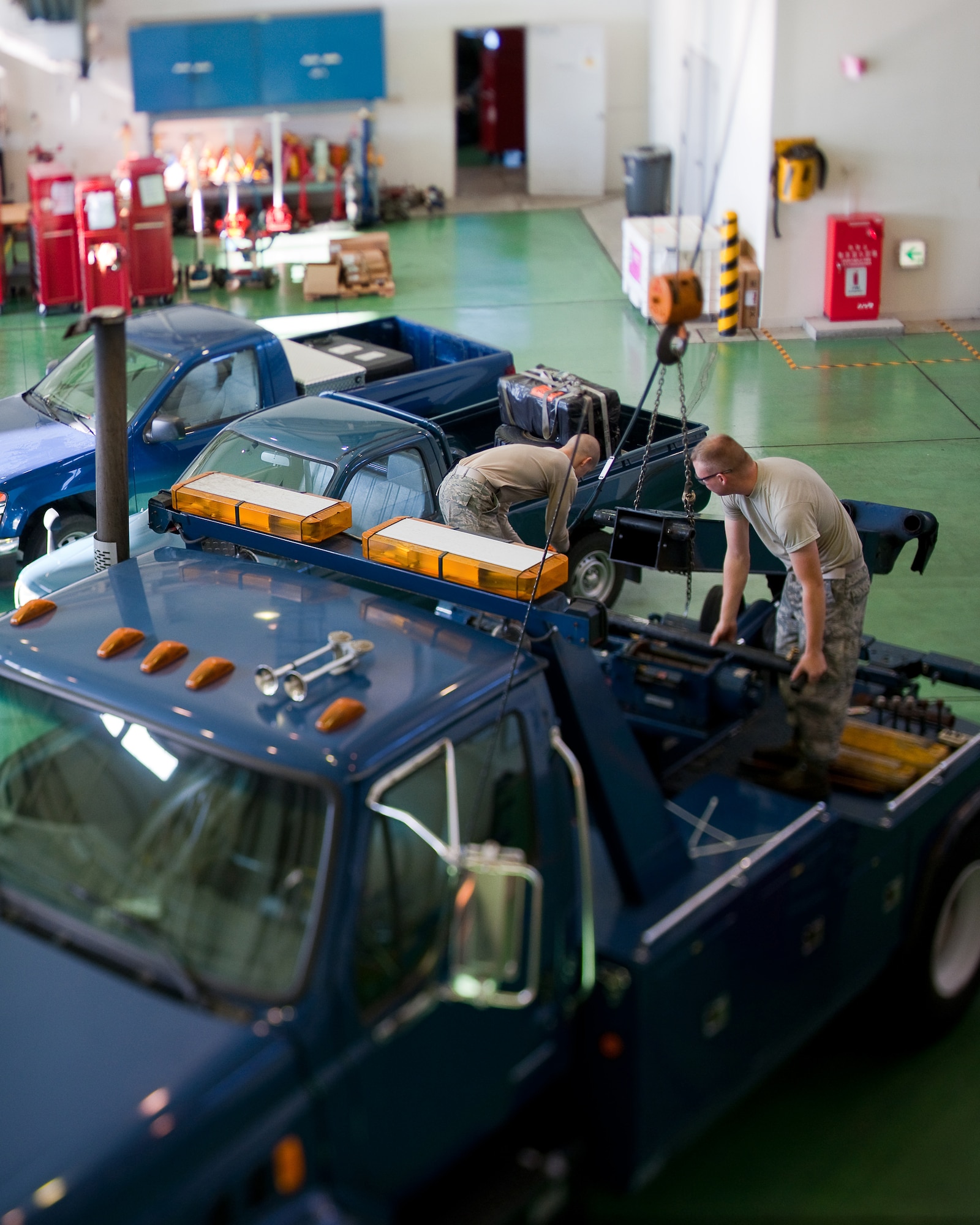 YOKOTA AIR BASE, Japan -- Members from the 374th Logistics Readiness Squadron maintain government vehicles here Dec. 15. Vehicle maintainers from the 374 LRS maintain over 1200 vehicles at Yokota. (U.S. Air Force photo/Osakabe Yasuo)