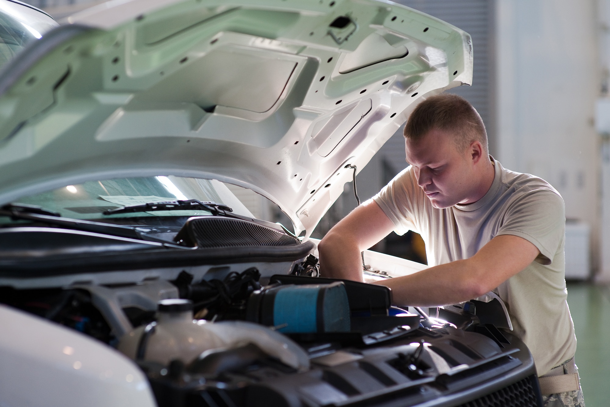 YOKOTA AIR BASE, Japan -- Airman 1st Class Martin Trost, 374th Logistics Readiness Squadron, performs maintenance on a government vehicle here Dec. 15. Vehicle maintainers from the 374 LRS maintain over 1200 vehicles in Yokota. (U.S. Air Force photo/Osakabe Yasuo)
