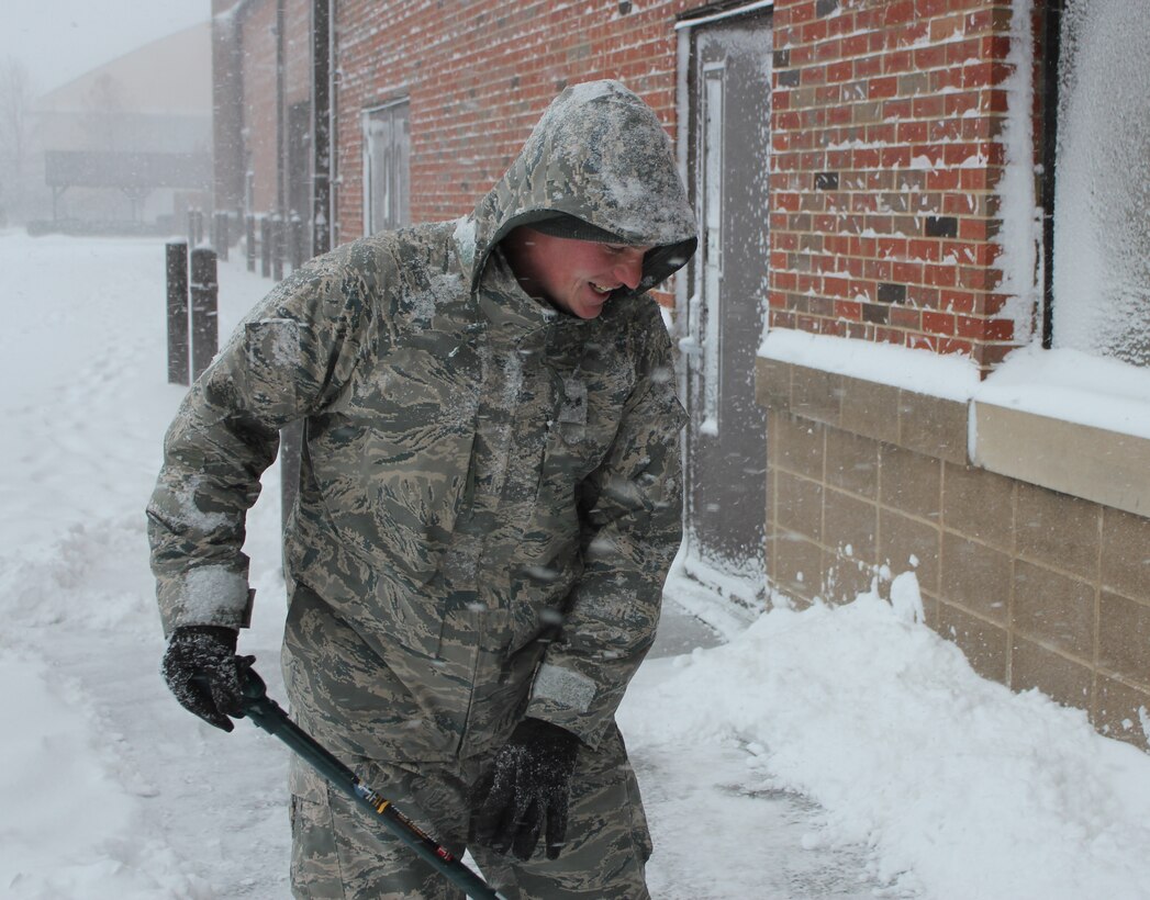 Scott Air Force Base, Ill.--Senior Airman Jebidiah Smail shovels snow outside the 932nd  Maintenance Group building at the December unit drill.  He was joined by other maintenance personnel who cleared walkways  around the facility.  This part of southern Illinois  was  hit with a winter storm packing high winds  that produced  several inches  of snow and plunging  temperatures.  (U.S. Air Force photo/Tech. Sgt. Dan Oliver).  
