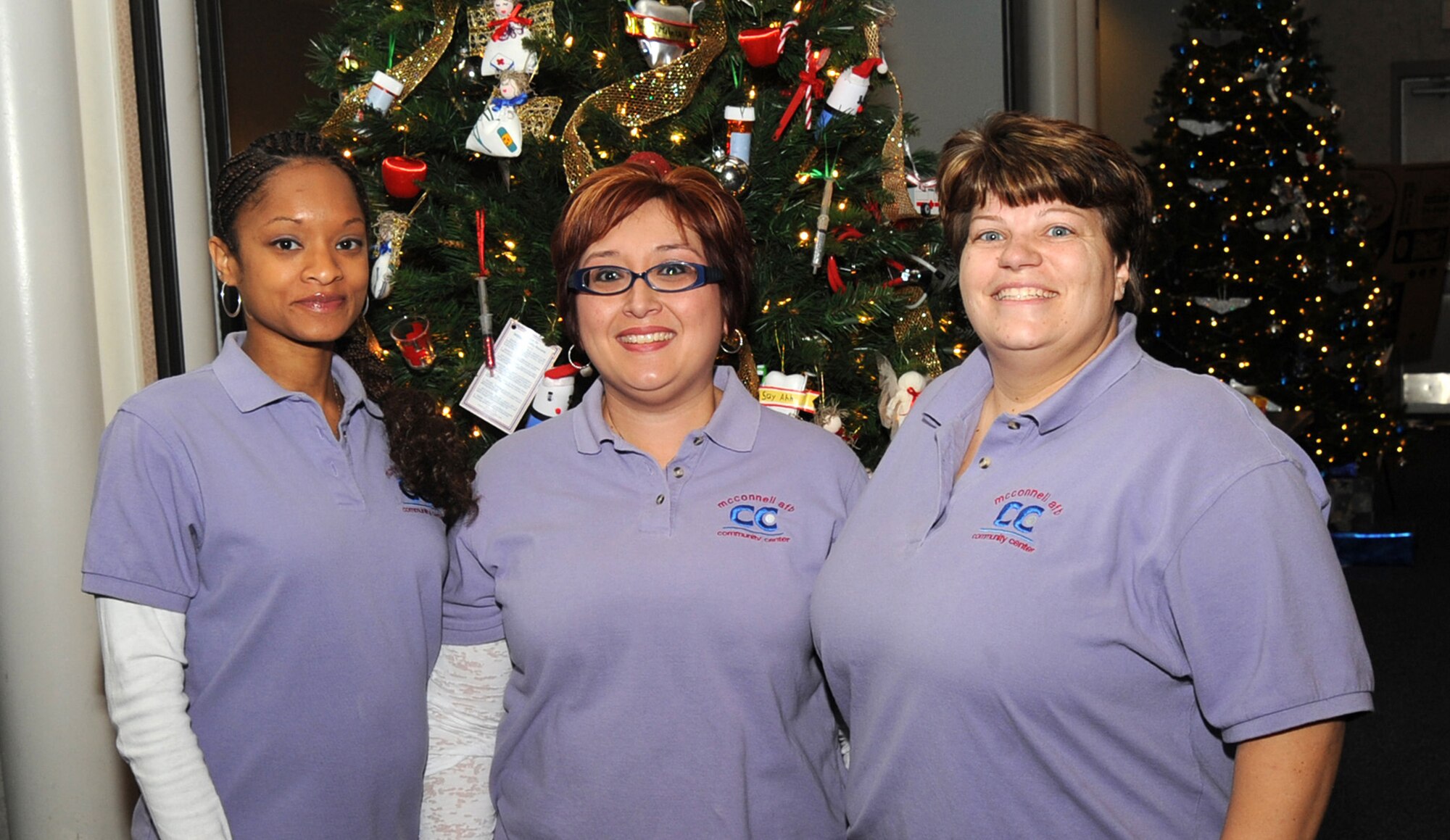 (Left to right) McConnell Air Force Base Community Center staff Altara Warren, 22nd Force Support Squadron recreation aide, Fe Vorderlandwehr, 22nd FSS Community Center director, and Cynthia Wilson, 22nd FSS recreation aide, pose for a picture during Santa’s visit Dec. 11, 2010, McConnell Air Force Base, Kan. Recently the Community Center was awarded Air Mobility Command’s Community Center Program of the Year award for hosting programs such as Santa’s Visit. (U.S. Air Force photo/Staff Sgt. Dallas Edwards)