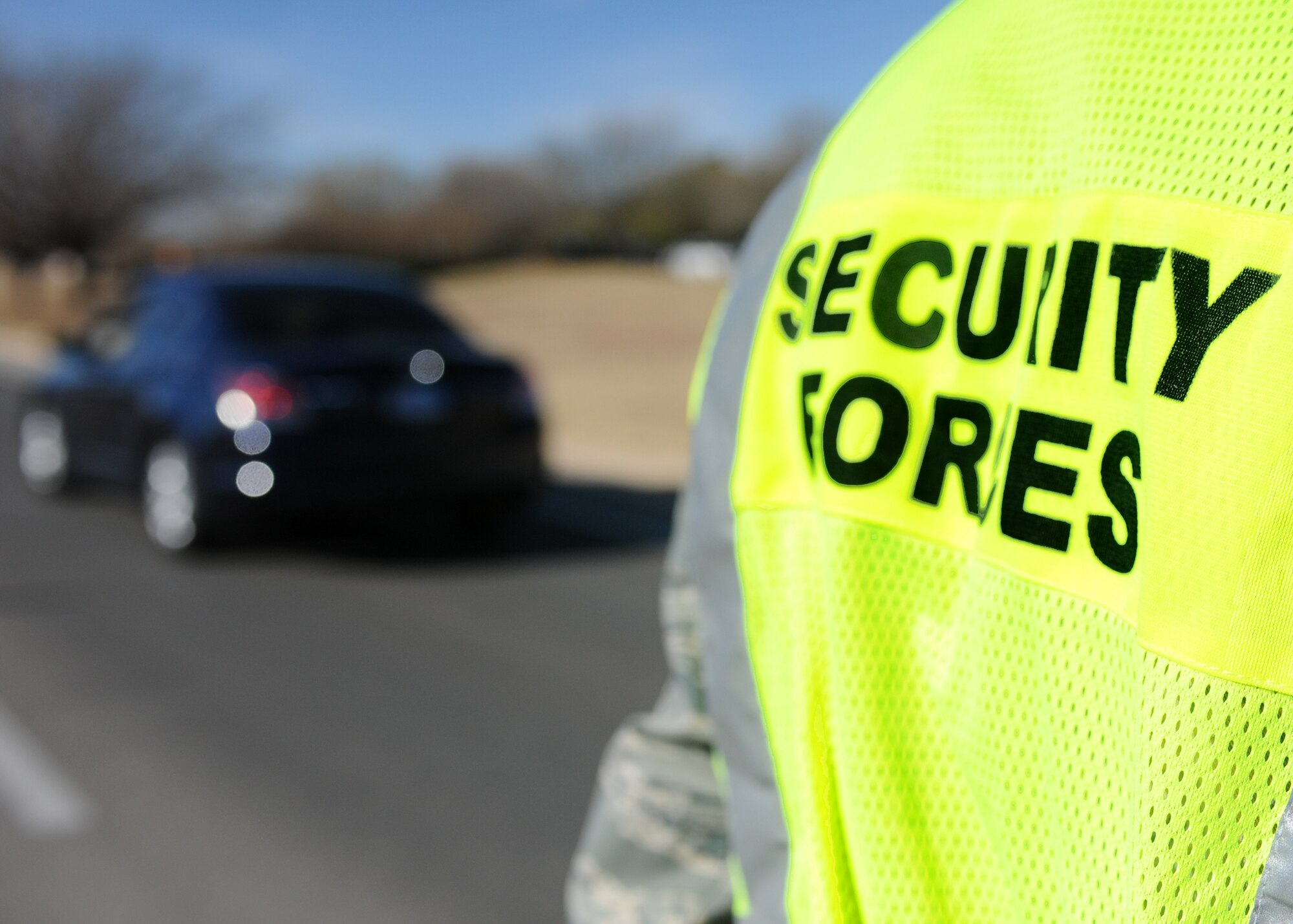 DYESS AIR FORCE BASE, Texas -- Members of the 7th Bomb Wing Safety Office and 7th Security Forces Squadron close traffic to one lane as they screen for individuals not wearing seatbelts and illegally using cellular phones Dec. 14, here.  Using a cellular phone while driving increases the chances of getting into an accident by 400 percent and failure to wear a seat belt contributes to more fatalities than any other single traffic safety-related behavior. (U.S. Air Force photo/Senior Airman Jenifer H. Calhoun)