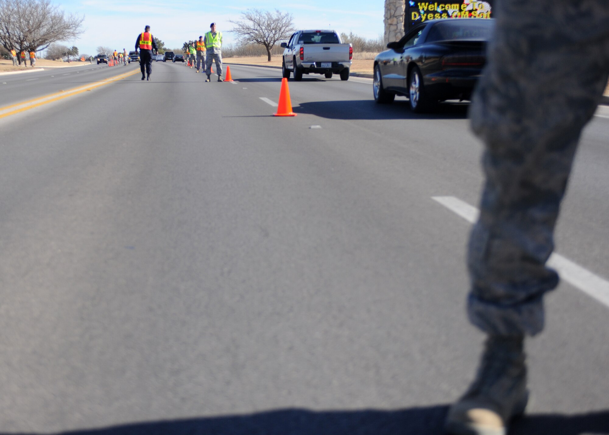 DYESS AIR FORCE BASE, Texas -- Members of the 7th Bomb Wing Safety Office and 7th Security Forces Squadron close traffic to one lane as they screen for individuals not wearing seatbelts and illegally using cellular phones Dec. 14, here.  Using a cellular phone while driving increases the chances of getting into an accident by 400 percent and failure to wear a seat belt contributes to more fatalities than any other single traffic safety-related behavior. (U.S. Air Force photo/Senior Airman Jenifer H. Calhoun)