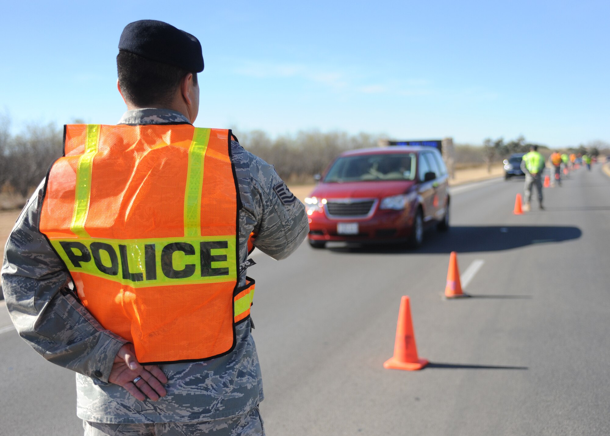 DYESS AIR FORCE BASE, Texas -- Members of the 7th Bomb Wing Safety Office and 7th Security Forces Squadron close traffic to one lane as they screen for individuals not wearing seatbelts and illegally using cellular phones Dec. 14, here.  Using a cellular phone while driving increases the chances of getting into an accident by 400 percent and failure to wear a seat belt contributes to more fatalities than any other single traffic safety-related behavior. (U.S. Air Force photo/Senior Airman Jenifer H. Calhoun)