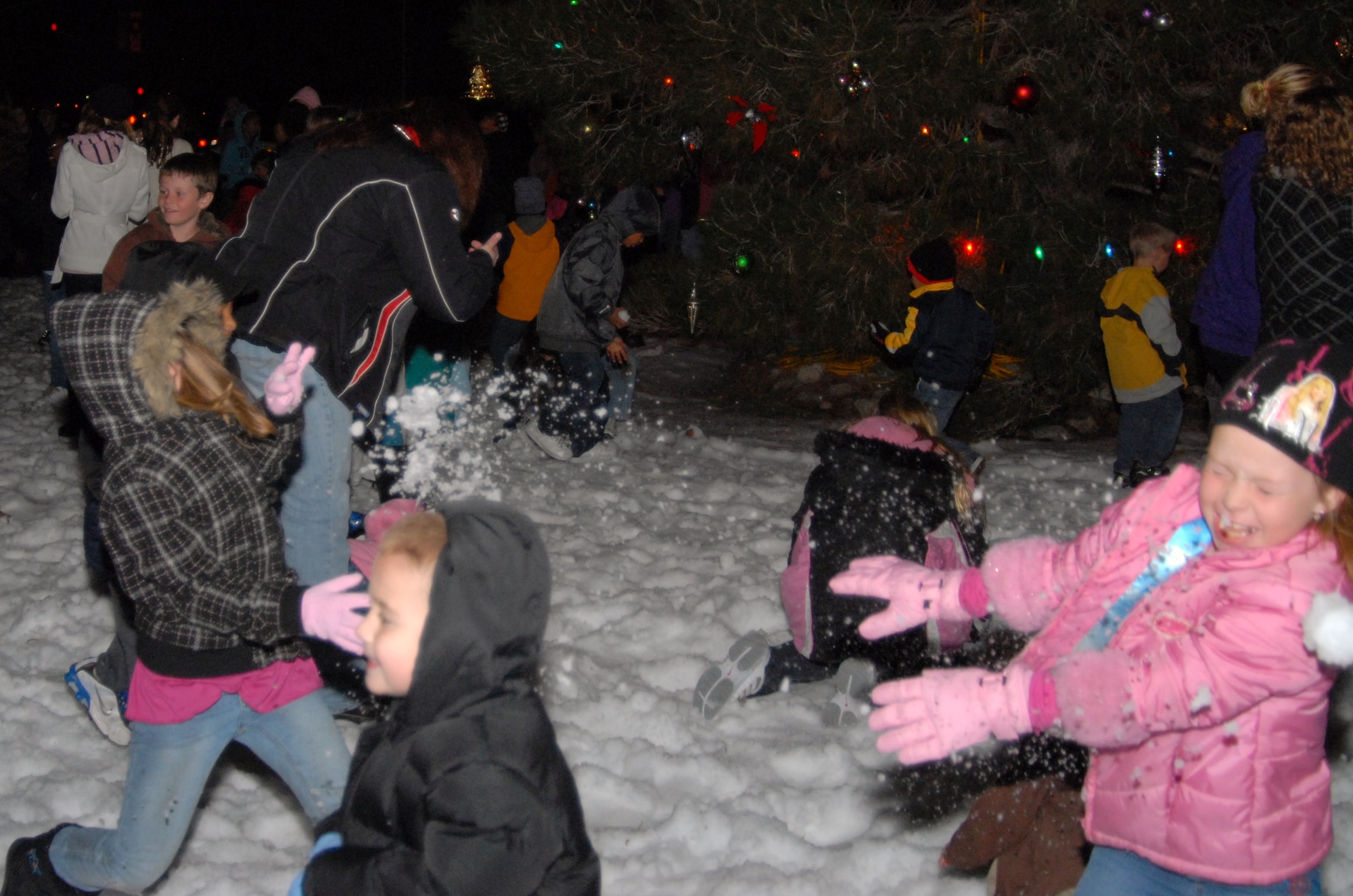 The 95th Force Support Squadron brought in nearly 30 tons of machine-made snow for this year's annual holiday tree lighting and snowball fight. Base residents, workers and families flocked to the tree lighting, Dec. 7, during an appropriately chilly winter night. (Air Force photo by Kenji Thuloweit)