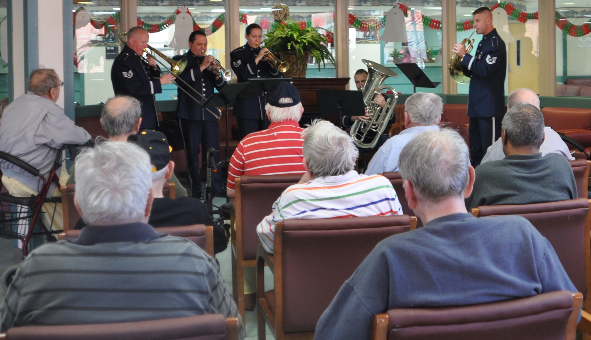 The Band of the U.S. Air Force Reserve's Brass Quintet brought holiday cheer to veterans at the Carl Vinson Veterans Administration Medical Center in Dublin, Dec. 13, 2010. The Reserve Brass ensemble performed four mini-concerts of holiday carols and sing-alongs. This visit is just a small way of saying thanks to veterans for all they have done for our country, said Master Sgt. Mike Andrew, trumpet player and non-commissioned officer-in-charge of the Brass Quintet. The Brass Quintet is the most versatile, small ensemble of the Band of the U.S. Air Force Reserve.  The quintet performs a variety of different community relations concerts throughout the southeast.   (U.S. Air Force photo/Candice Allen)
