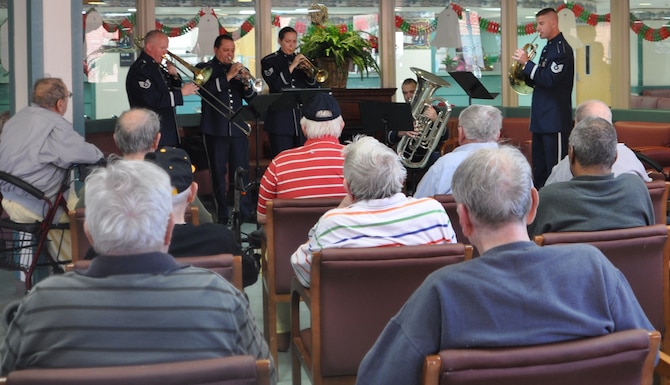 The Band of the U.S. Air Force Reserve's Brass Quintet brought holiday cheer to veterans at the Carl Vinson Veterans Administration Medical Center in Dublin, Dec. 13, 2010. The Reserve Brass ensemble performed four mini-concerts of holiday carols and sing-alongs. This visit is just a small way of saying thanks to veterans for all they have done for our country, said Master Sgt. Mike Andrew, trumpet player and non-commissioned officer-in-charge of the Brass Quintet. The Brass Quintet is the most versatile, small ensemble of the Band of the U.S. Air Force Reserve.  The quintet performs a variety of different community relations concerts throughout the southeast.   (U.S. Air Force photo/Candice Allen)
