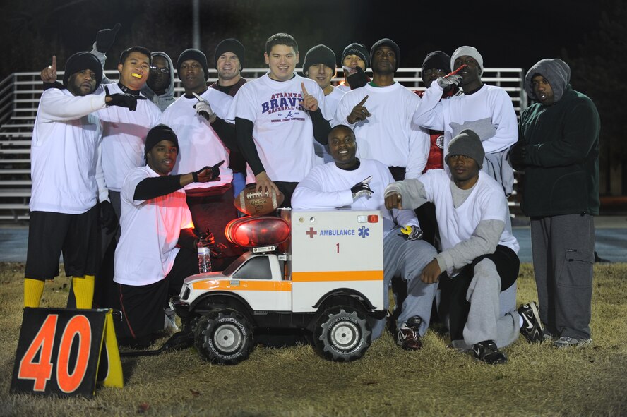 MOODY AIR FORCE BASE, Ga. -- The 23rd Medical Group’s flag football team poses for a photo after winning the championship flag football game against the 23rd Operational Support Squadron Dec. 13. The team was fired up as they had to win not only the first game that was played but also a follow-up match because of already losing a match in the tournament. (U.S. Air Force photo/Airman 1st Class Douglas Ellis)(RELEASED)
