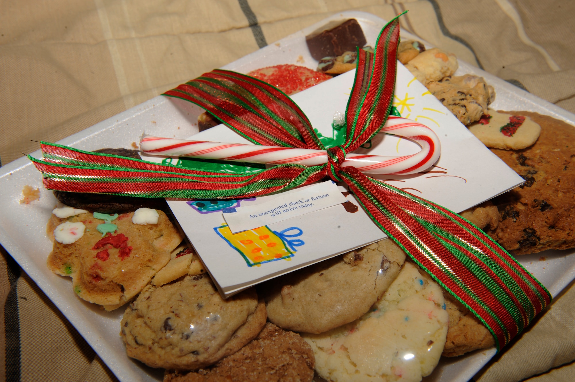 HOLLOMAN AIR FORCE BASE, N.M. -- A cookie package delivered by a First Sergeant, sits on an Airman's bed at the base dormitories Dec. 13, 2010. The cookies are from the annual Airman Cookie Drive, where members of the local community bake and donate cookies for all of the Airmen living in the dorms. The goal for this year was to give each Airman a dozen cookies, but with all of the contributions from Team Holloman and the local community, the Airmen received two dozen each. (U.S. Air Force photo by Airman 1st Class Eileen Payne/Released)