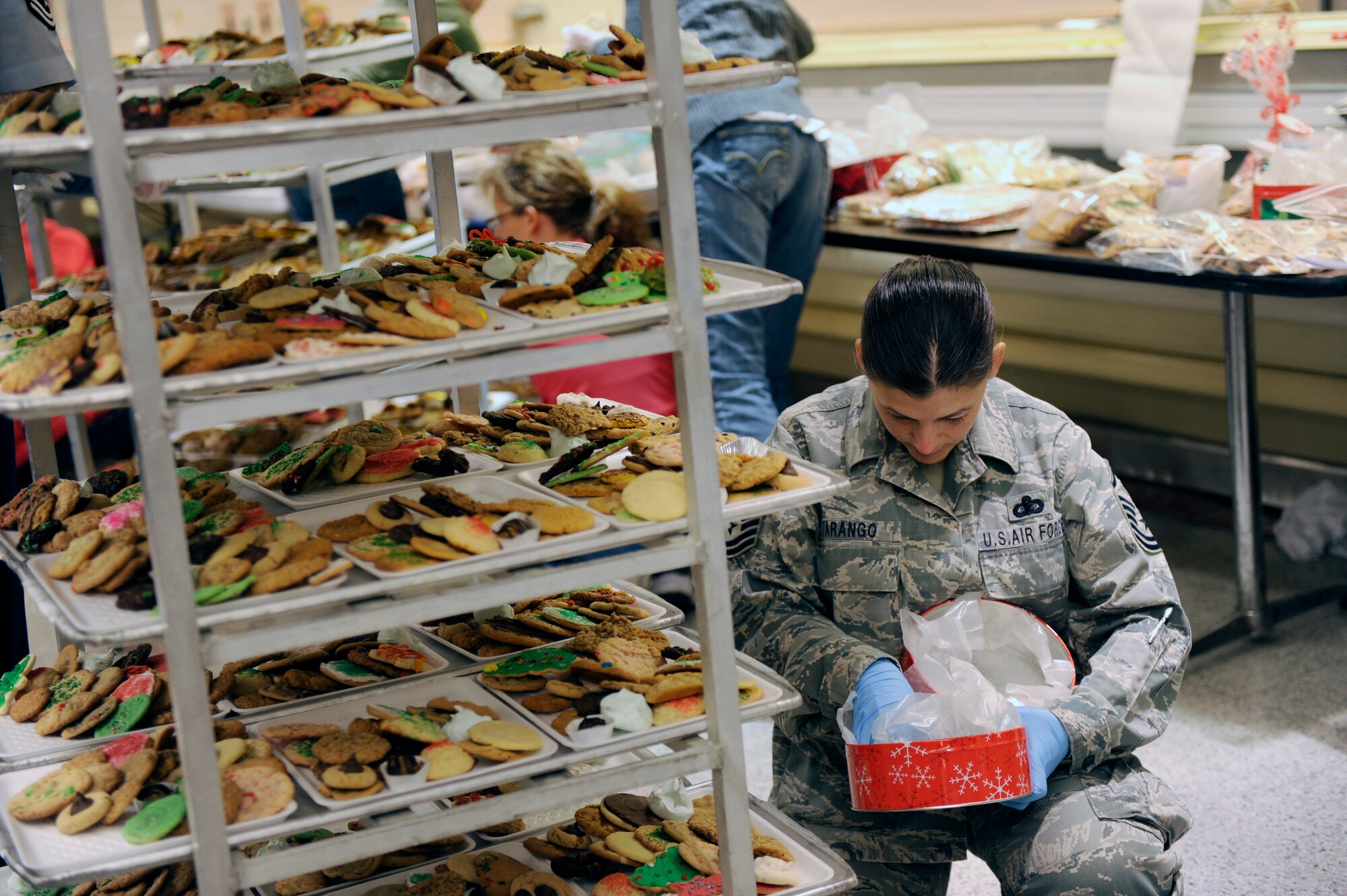 HOLLOMAN AIR FORCE BASE, N.M. -- Master Sgt. Melissa Tarango, 49th Medical Group Dental Flight, helps sort cookies for the annual Airman Cookie Drive at the base commissary Dec. 13, 2010. Volunteers from different squadrons around the base came together to help out with the packaging of the cookies, and also personally delivered them to the Airmen living in the dorms. The goal for this year was to give each Airman a dozen cookies, but with all the contributions from Team Holloman and the local community, the Airmen received two dozen each. (U.S. Air Force photo by Airman 1st Class Eileen Payne/Released)