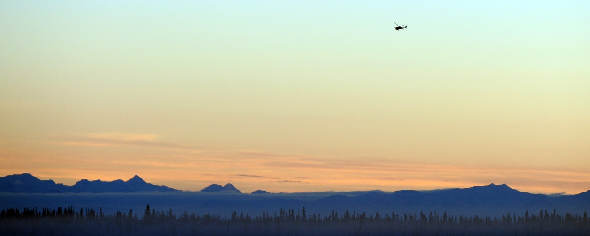 Alpha Company 1-52 Aviation, 16th Combat Aviation Brigade, flies a UH-60 Black Hawk into the sunset during the onset of the winter solstice at Eielson Air Force Base, Alaska Dec. 8, 2010. The day light gradually decreases as we approach the shortest day of the year, Dec. 21. (U.S. Air Force photo/Airman 1st Class Laura Goodgame) 