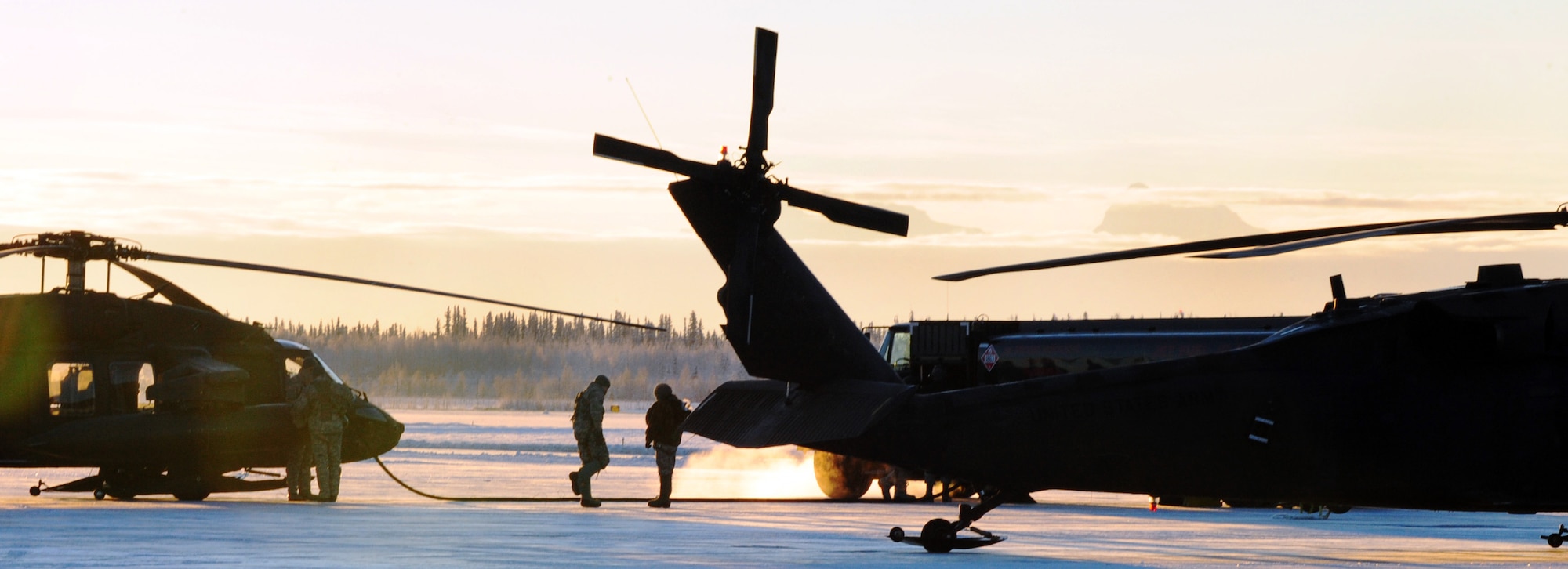 Soldiers assigned to Alpha Company 1-52 Aviation, 16th combat aviation brigade make a pit stop at Eielson Air Force Base, Alaska Dec. 8, 2010. The soldiers stopped to refuel two UH-60 Black Hawks during a routine training exercise. (U.S. Air Force photo/Airman 1st Class Laura Goodgame) 