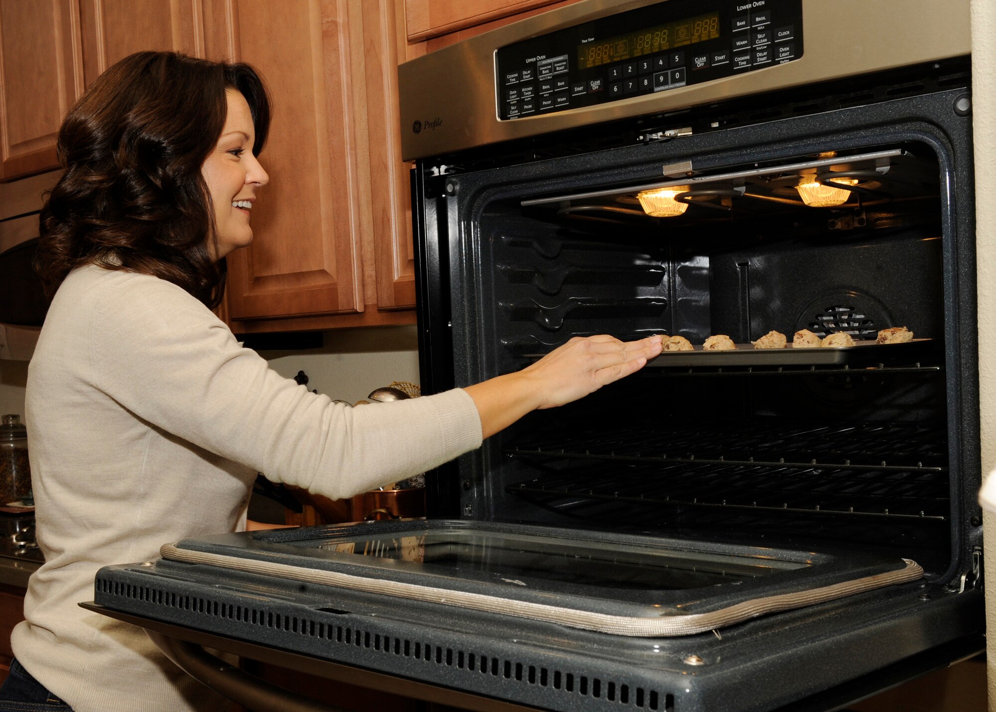 HOLLOMAN AIR FORCE BASE, N.M -- Lisa Krumm, wife of Col. David Krumm, 49th Wing commander, bakes cookies for the annual Airman Cookie Drive in her home Dec. 10, 2010. Mrs. Krumm was the organizer for this year's drive and set the drive's goal of 600 dozen, which was surpassed by more than 800 dozen. After the cookies were wrapped by volunteers from the commissary, they were delivered directly to the Airmen in their dorms by their First Sergeants. (U.S. Air Force photo by Airman 1st Class Eileen Payne/Released)