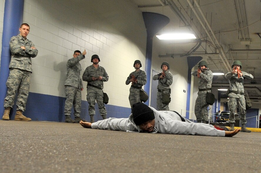 OFFUTT AIR FORCE BASE, Neb. ? Airman 1st Class Kesean Lawrence from the 55th Security Forces Squadron, is apprehended by Combat Rodeo participants in the Martin Bomber Building Dec. 10. Teams from across the 55th Wing demonstrated proper techniques of donning chemical protection gear, performing self-aid and buddy care and defending entries. U.S. Air Force photo by Jeff W. Gates (Released)