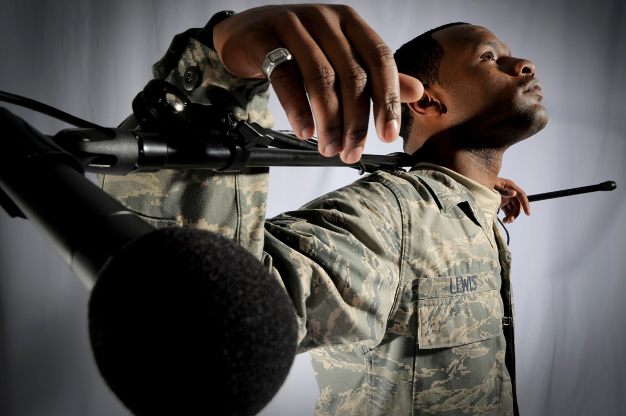 JOINT BASE ELMENDORF-RICHARDSON, Alaska -- Airman 1st Class Kerry Lewis, 3rd Maintenance Operation Squadron, poses with a mic stand here, Dec 14. Lewis performed a spoken word poem at a local establishment for the Anchorage Speakeasy on Dec. 10. Lewis plans to sharpen his gift by continuing to perform in local spoken word events. (U.S. Air Force Photo/ Staff Sgt. Joshua Garcia)
