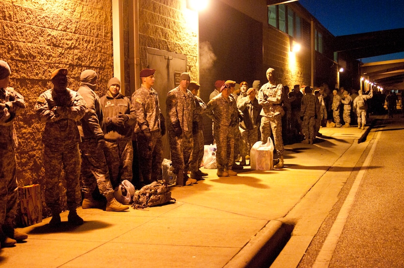 Paratroopers line up in the early morning of Dec. 10 to donate a toy in hopes to earn foreign jump wings tomorrow during Operation Toy Drop on Fort Bragg. Operation Toy Drop started out as a small mission, with 800 paratroopers jumping. Today, the event attracts more interested paratroopers than there are parachutes and time available. (U.S. Army photo/Staff Sgt. Sharilyn Wells/USACAPOC(A) PAO)