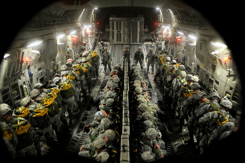 U.S. and allied jumpmasters prepare paratroopers to parachute out of a Joint Base Charleston, S.C., C-17A Globemaster III  prior to arriving to the jump zone in support of Operation Toy Drop, Dec. 11, 2010 in the air above North Carolina. Operation Toy Drop is an international exercise that trains allied jumpmasters to work with U.S. active duty and Air Force Reserve Command paratroopers. (U.S. Air Force photo/Tech. Sgt. Manuel J. Martinez)