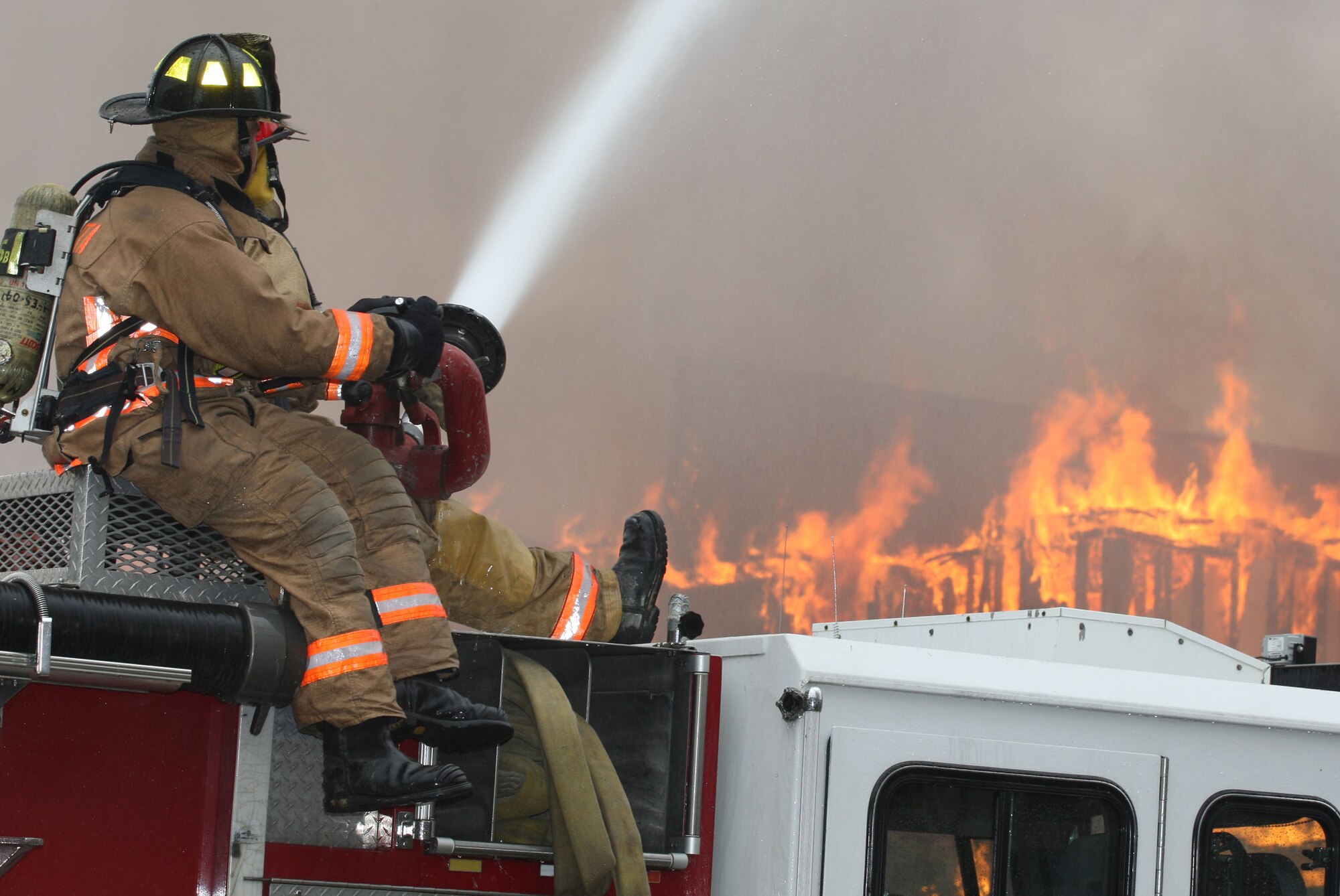 Fire Crews from both the Dobbins Fire and Emergency Services and Marietta Fire Department team up to perform live fire training scenario. (U.S. Air Force Photo/Don Peek) 