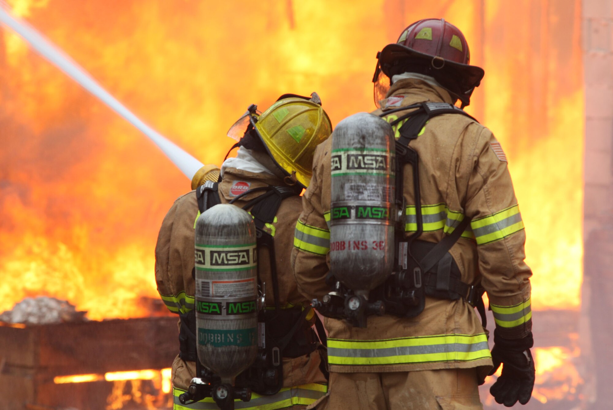 Firefighters from Dobbins Fire and Emergency Services take on the blaze as it completely consumes the apartment complex in live fire training. (U.S. Air Force Photo/Don Peek) 