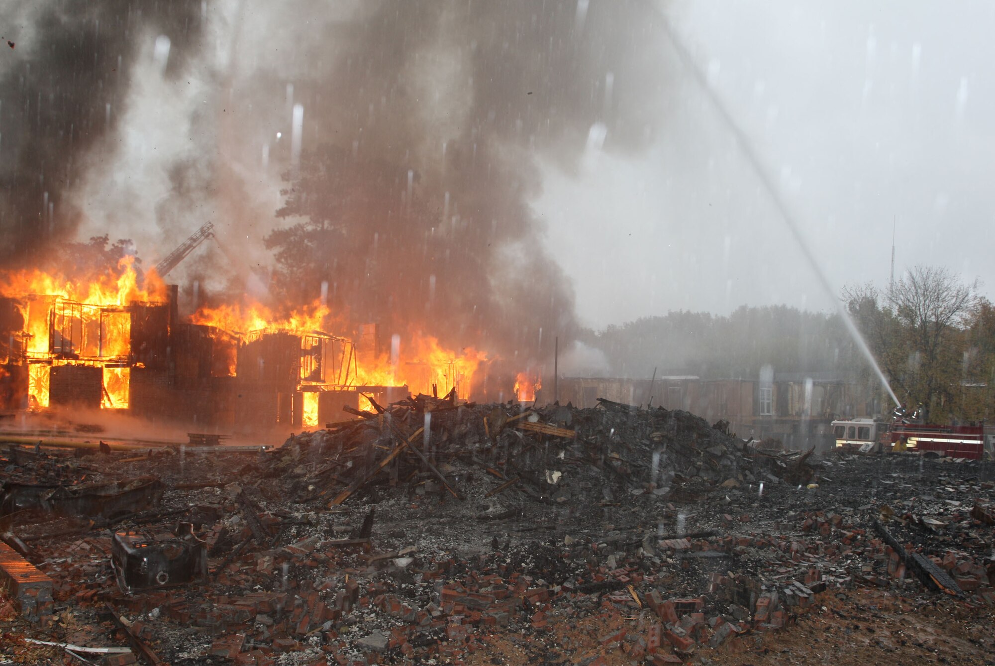 Firefighting teams attack the intense apartment complex blaze from various positions. (U.S. Air Force Photo/Don Peek) 