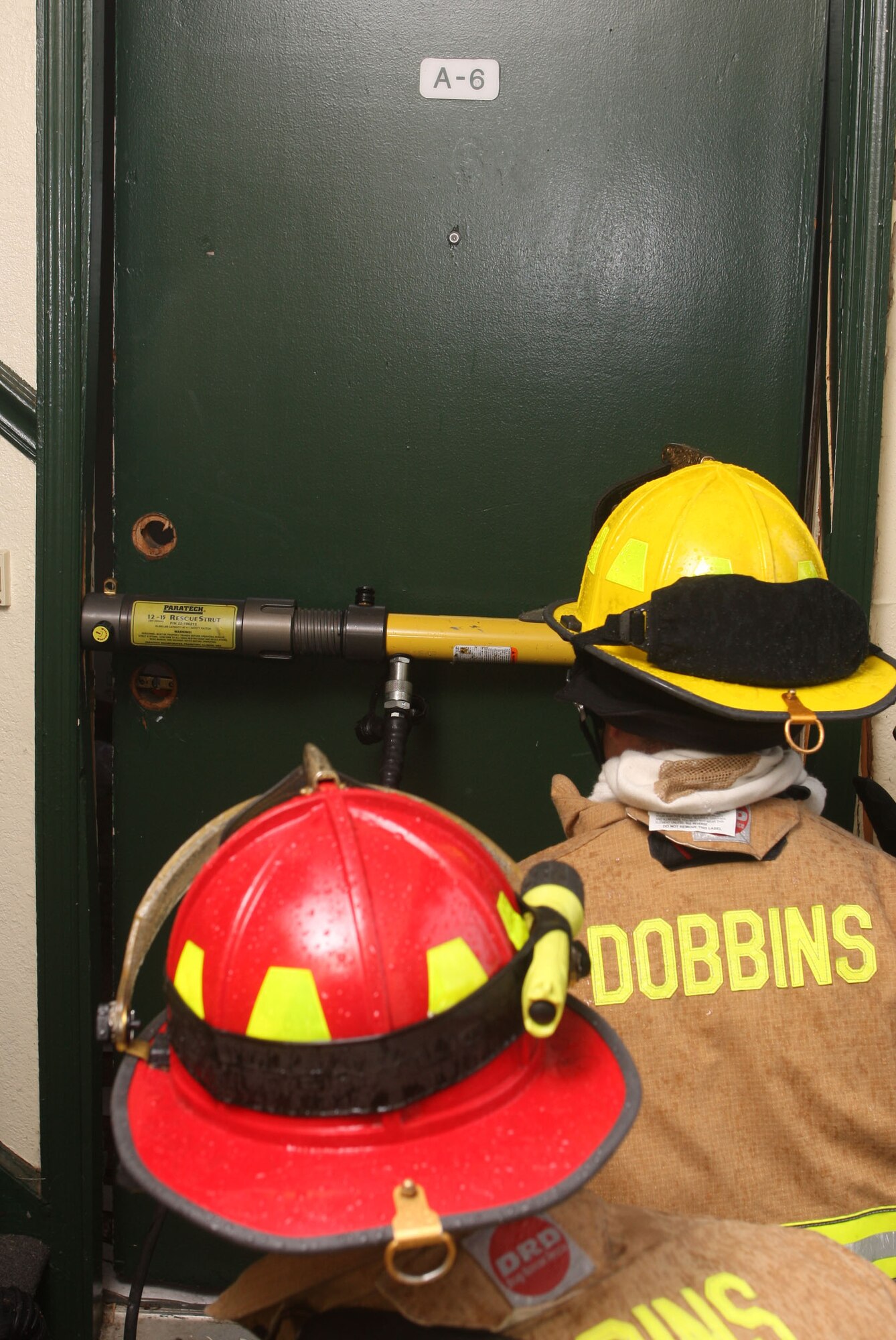 Firefighters from Dobbins Fire and Emergency Services separate a door jamb while training on various techniques and equipment for forcible entry. (U.S. Air Force Photo/Don Peek)