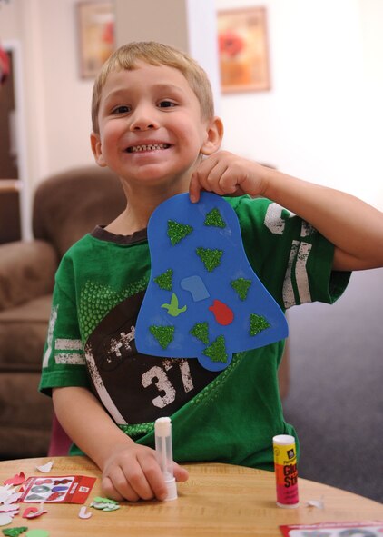 DYESS AIR FORCE BASE, Texas—Four-year-old Coby Hauf shows off his Christmas ornament Dec. 14 at the Dyess library here. Library assistants set up different stations where children could make an assortment of Christmas ornaments to take home. While making their ornaments the children enjoyed snacks, movies and Christmas music. (U.S Air Force photo/ Airman 1st Class Shannon Hall)