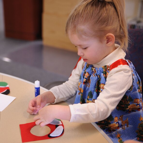 DYESS AIR FORCE BASE, Texas—Two-year-old Ella Tryon decorates a Christmas stocking Dec. 14 at the Dyess library here. Library assistants set up different stations where children could make an assortment of Christmas ornaments to take home. While making their ornaments the children enjoyed snacks, movies and Christmas music. (U.S Air Force photo/ Airman 1st Class Shannon Hall)