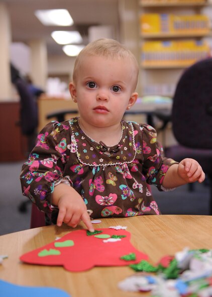 DYESS AIR FORCE BASE, Texas—One-year-old Brooklyn Hauf decorates an ornament Dec. 14 at the Dyess library here. Library assistants set up different stations where children could make an assortment of Christmas ornaments to take home. While making their ornaments, the children enjoyed snacks, movies and Christmas music. (U.S Air Force photo/ Airman 1st Class Shannon Hall) 