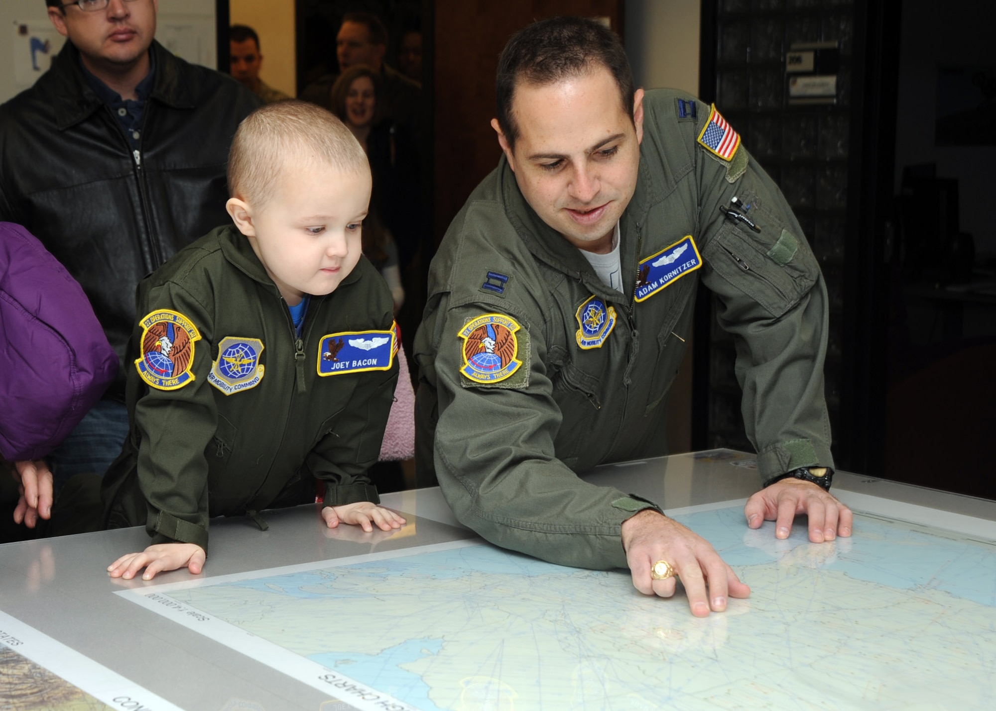 Capt. Adam Kornitzer, 22nd Operations Support Squadron flight instructor, shows 5-year-old Joey Bacon, Pilot for a Day recipient, a map of the United States while explaining the 22nd OSS’s missions Dec. 10, 2010, McConnell Air Force Base, Kan. Joey, who has been diagnosed with leukemia, was invited to the base by members of the 22nd OSS as part of the Pilot For a Day program, an Air Force program that allows medically-challenged youth a chance to visit the base and participate in base operations. (U.S. Air Force photo/Staff Sgt. Dallas Edwards