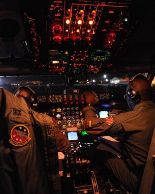 Lt. Col. Brian Hill, 96th Air Refueling Squadron commander and aircraft commander for the squadron's first operational refueling mission (right), and Capt. Jasmine McCann, 96th ARS pilot prepare a KC-135 Stratotanker for flight Dec. 14 at Joint Base Pearl Harbor-Hickam, Hawaii. During the mission, a 96th ARS KC-135 joined a KC-135 from the Iowa Air National Guard as part of a two-ship formation to refuel two B-52 Stratofortresses on the way to Guam. (U.S. Air Force photo/Staff Sgt. Nathan Allen)