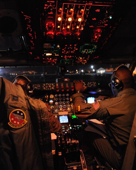 Lt. Col. Brian Hill, 96th Air Refueling Squadron commander and aircraft commander for the squadron's first operational refueling mission (right), and Capt. Jasmine McCann, 96th ARS pilot prepare a KC-135 Stratotanker for flight Dec. 14 at Joint Base Pearl Harbor-Hickam, Hawaii. During the mission, a 96th ARS KC-135 joined a KC-135 from the Iowa Air National Guard as part of a two-ship formation to refuel two B-52 Stratofortresses on the way to Guam. (U.S. Air Force photo/Staff Sgt. Nathan Allen)