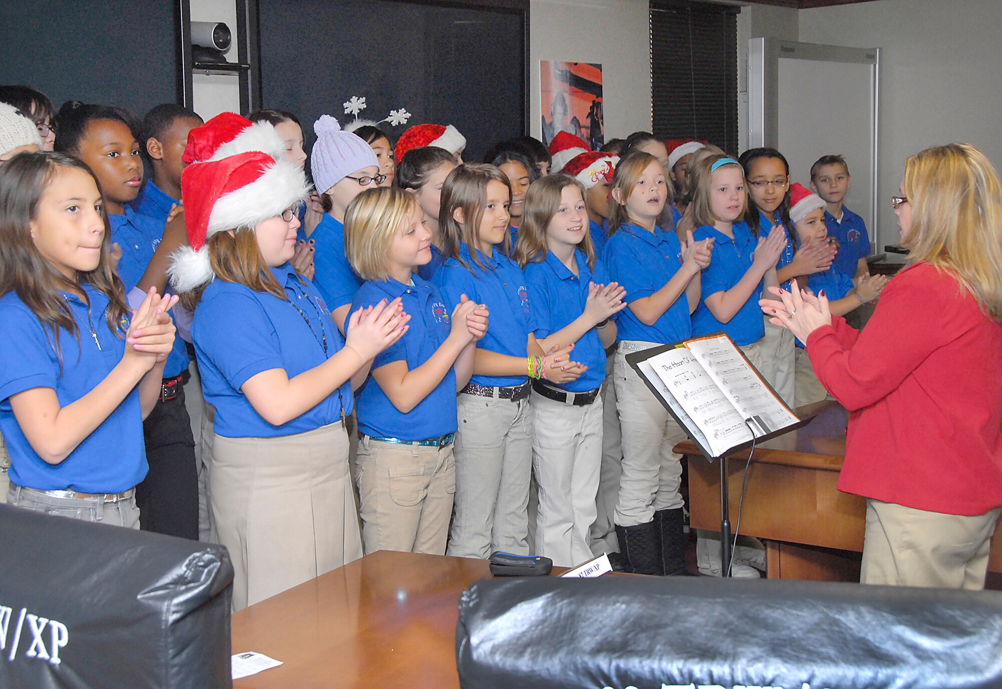 Students from Sheppard Elementary School perform a holiday song Dec. 13 in the 82nd Training Wing conference room. The students make the trek to the wing headquarters every year to sing songs to usher in the holiday season. (U.S. Air Force photo/Harry Tonemah)