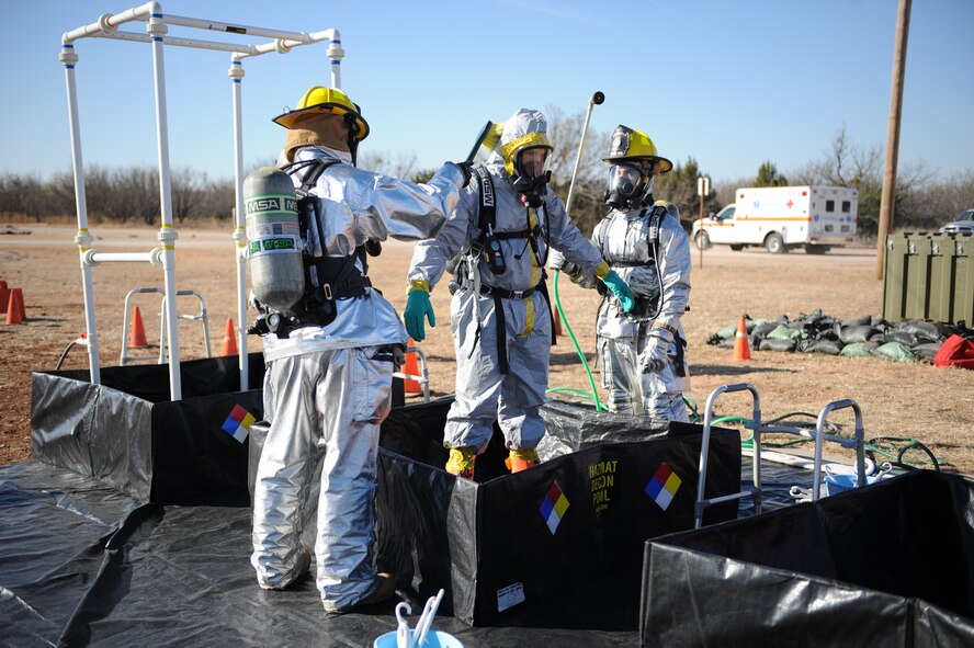 DYESS AIR FORCE BASE, Texas—Dyess firefighters simulate decontaminating one of their own Dec. 10 during an emergency management exercise at the cantonment area here. EMEs are conducted to test the wings capability to respond and coordinate with agencies off base in real world emergencies.  (U.S Air Force photo/ Airman 1st Class Shannon Hall)
