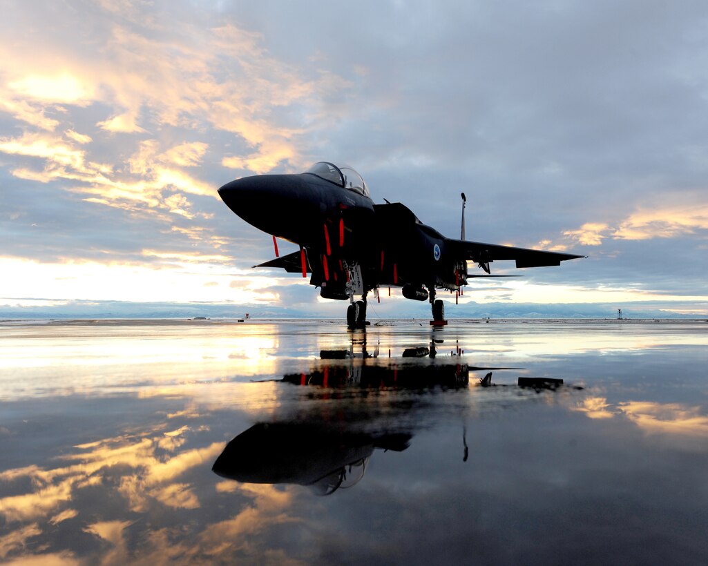 The wing commander's F-15E Strike Eagle assigned to the 389th Fighter Squadron sits on the flightline during sunset Dec. 6, 2010, at Mountain Home Air Force Base, Idaho. The aircraft is equipped with a low-altitude navigation and targeting infrared for night system, which allows the F-15E to fly at low altitudes, at night and in any weather conditions, to attack ground targets with a variety of precision-guided and unguided weapons. The LANTIRN system gives the aircraft unequaled accuracy in weapons delivery day or night and in poor weather, and consists of two pods attached to the exterior of the aircraft. (U.S. Air Force photo/Senior Airman Debbie Lockhart)