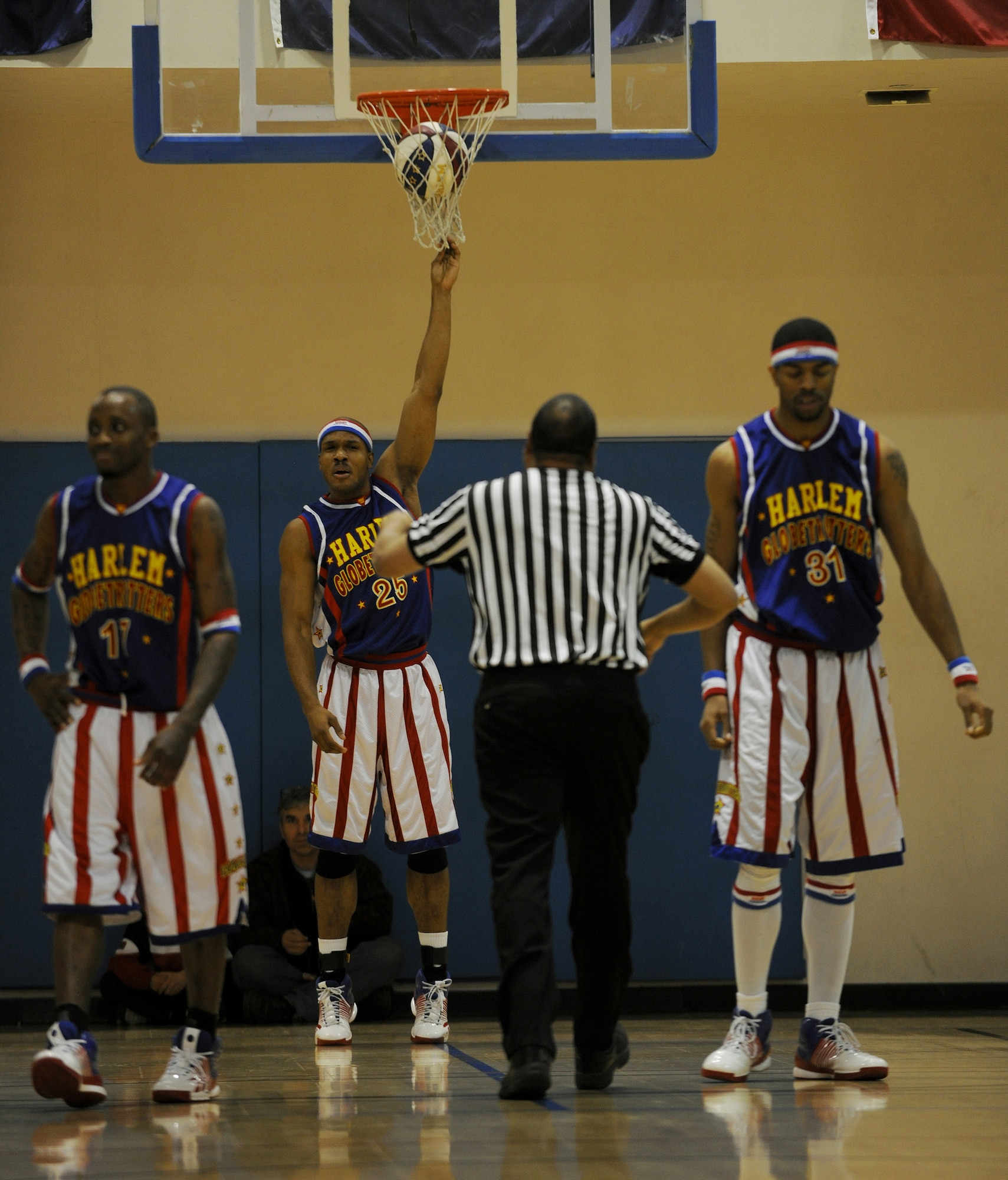 RAF MILDENHALL, England -- Zeus Stewart holds the net to keep the ball from going through the opposing team's basket here Dec. 11, 2010.  Globetrotters, who were charged with acts of tomfoolery during the game, were sent to the penalty chair for 10 seconds. (U.S. Air Force photo/Senior Airman Tabitha M. Lee) 