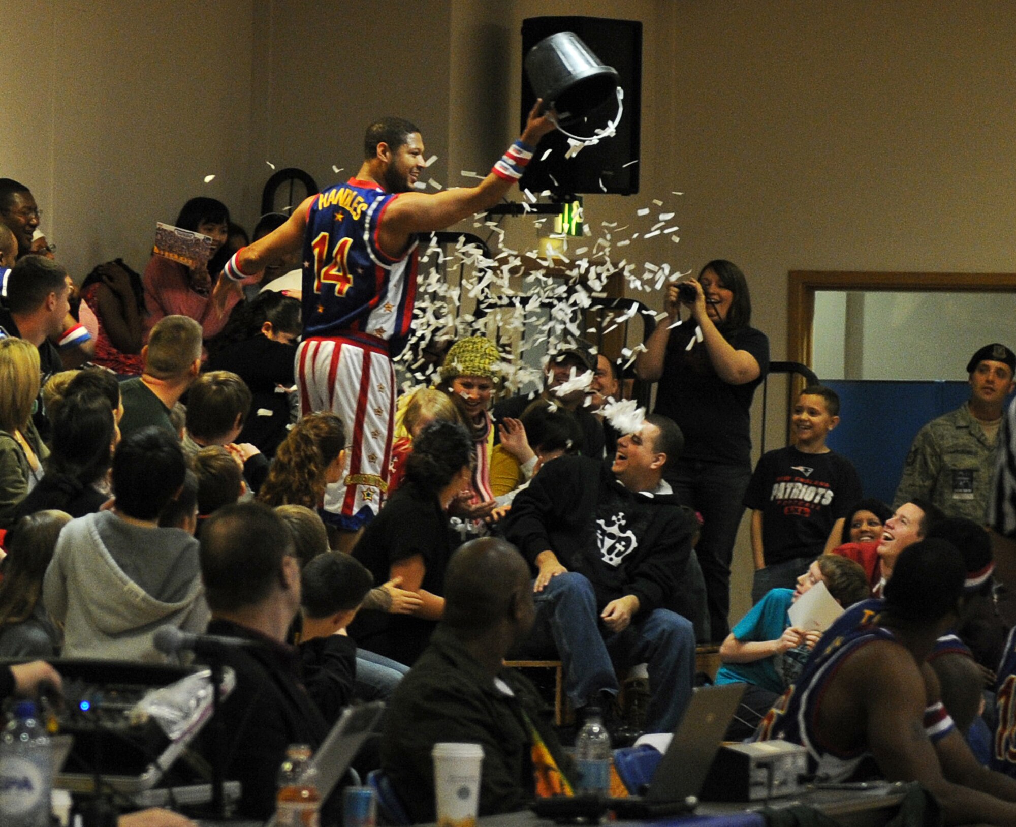 RAF MILDENHALL, England -- Handles Franklin pours shredded paper on the crowd here Dec. 11, 2010.  The Harlem Globetrotters' performance combines athleticism, theater and comedy for family friendly entertainment. (U.S. Air Force photo/Senior Airman Tabitha M. Lee)