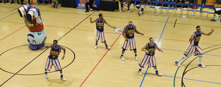 RAF MILDENHALL, England -- The Harlem Globetrotters 'break it down' with 'Big G' during halftime here Dec. 11, 2010.  'Big G' is the big brother of the Globetrotter mascot, Globie. (U.S. Air Force photo/Senior Airman Tabitha M. Lee)   