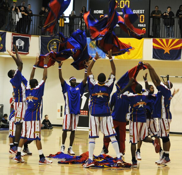 RAF MILDENHALL, England -- The Harlem Globetrotters remove their warm-up outfits before a game here Dec. 11, 2010.  The Globetrotters were created by Abe Saperstein in Chicago Ill. in 1926. (U.S. Air Force photo/Senior Airman Tabitha M. Lee)