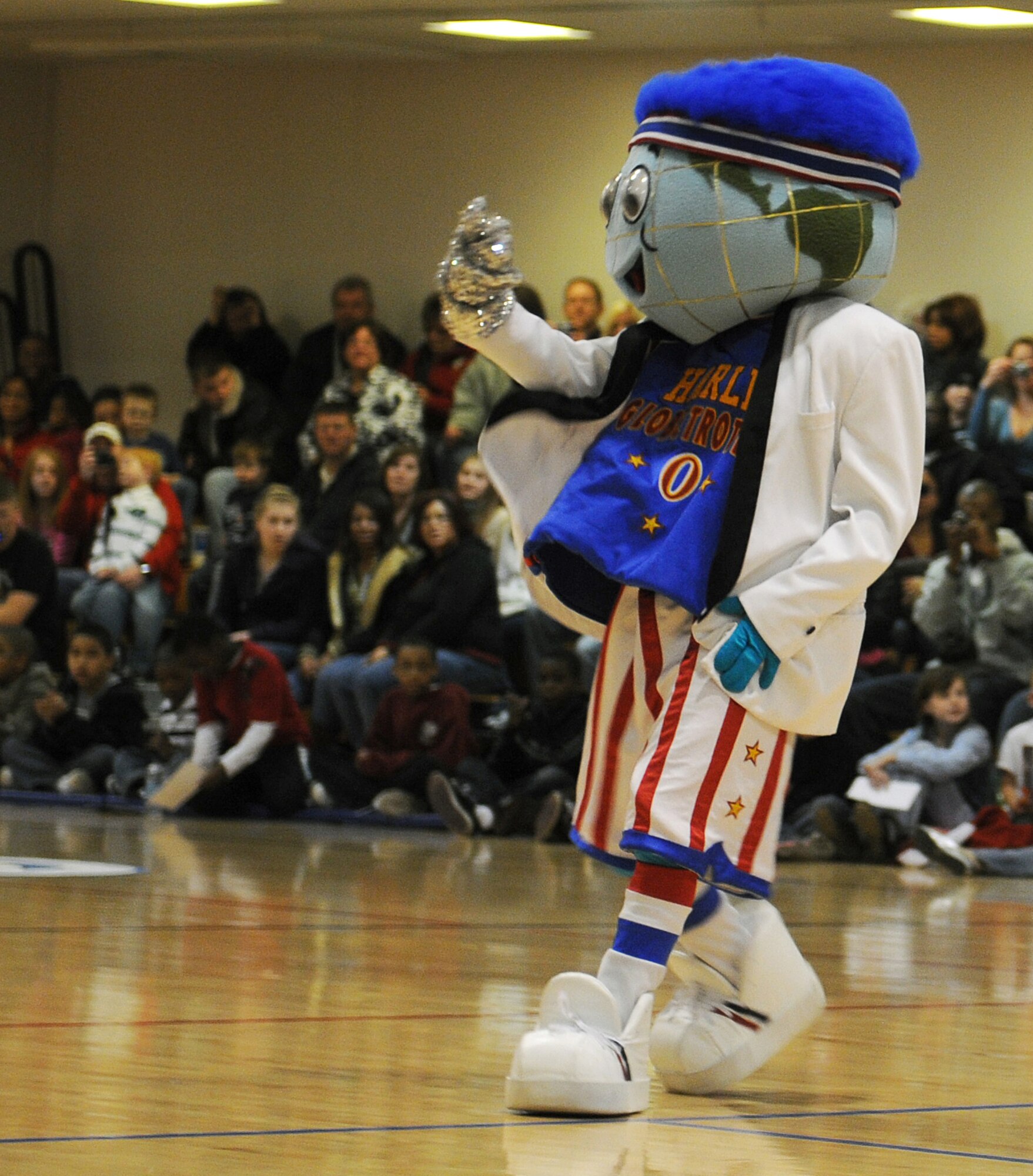 RAF MILDENHALL, England -- Globie, the Harlem Globetrotters' mascot, performs between quarters here Dec. 11, 2010. Globie has been the team's mascot since 1993. (U.S. Air Force photo/Senior Airman Tabitha M. Lee)   