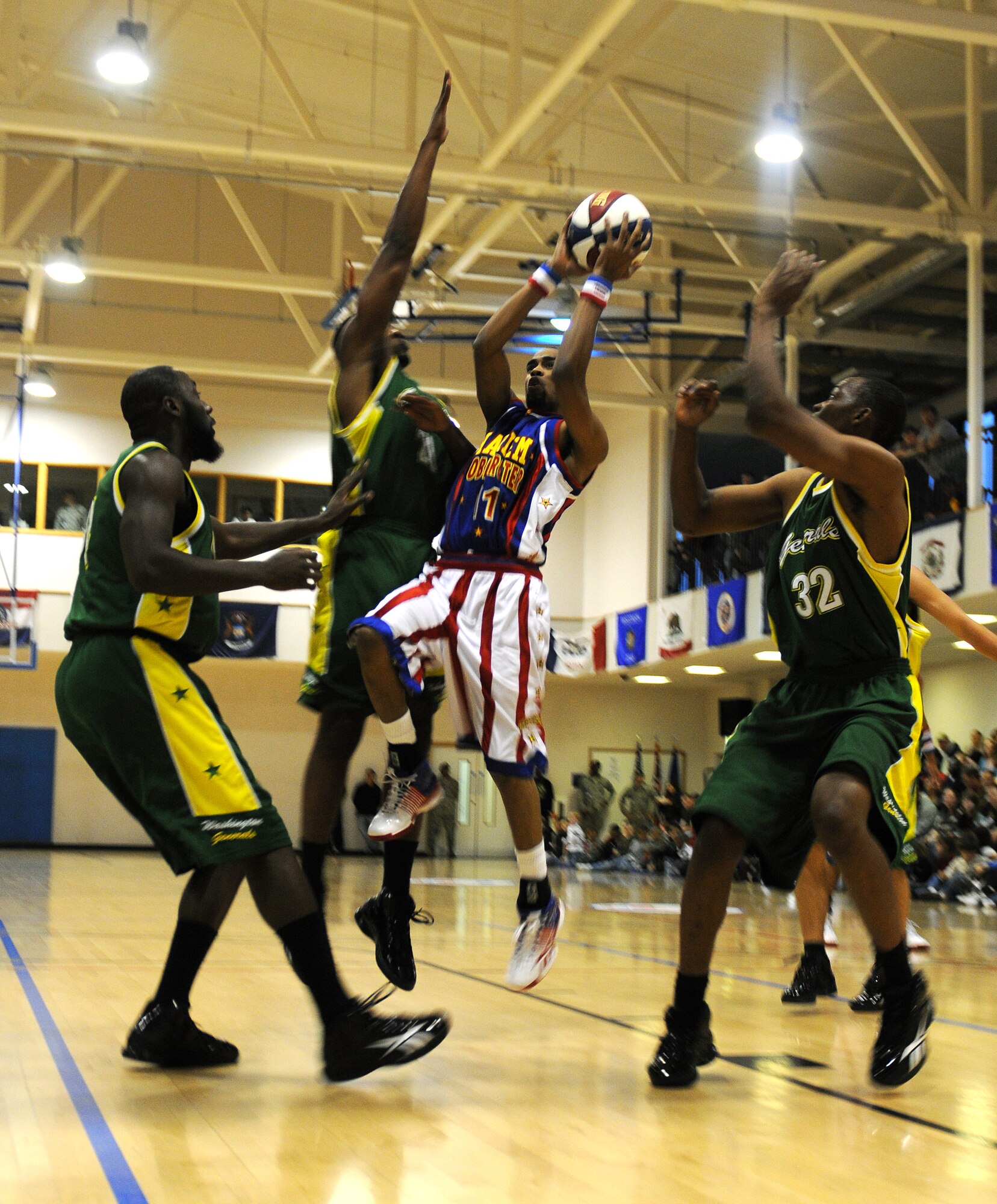 RAF MILDENHALL, England -- Cheese Chisholm shoots through the General's defense here Dec. 11, 2010.  The General's are an expeditionary team that travels with the Globetrotters as part of their show.  More than 750 servicemembers and their families came out to watch the Harlem Globetrotters. (U.S. Air Force photo/Senior Airman Tabitha M. Lee)   