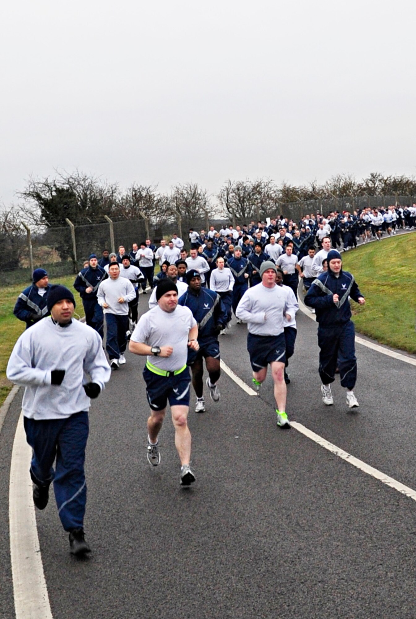 RAF MILDENHALL, England – Team Mildenhall members charge around the perimeter road as part of the monthly 5K run Dec. 10, 2010. Hundreds of 100th Air Refueling Wing and tenant unit Airmen participated in the monthly run to promote health and fitness. (U.S. Air Force photo/Senior Airman Ethan Morgan)