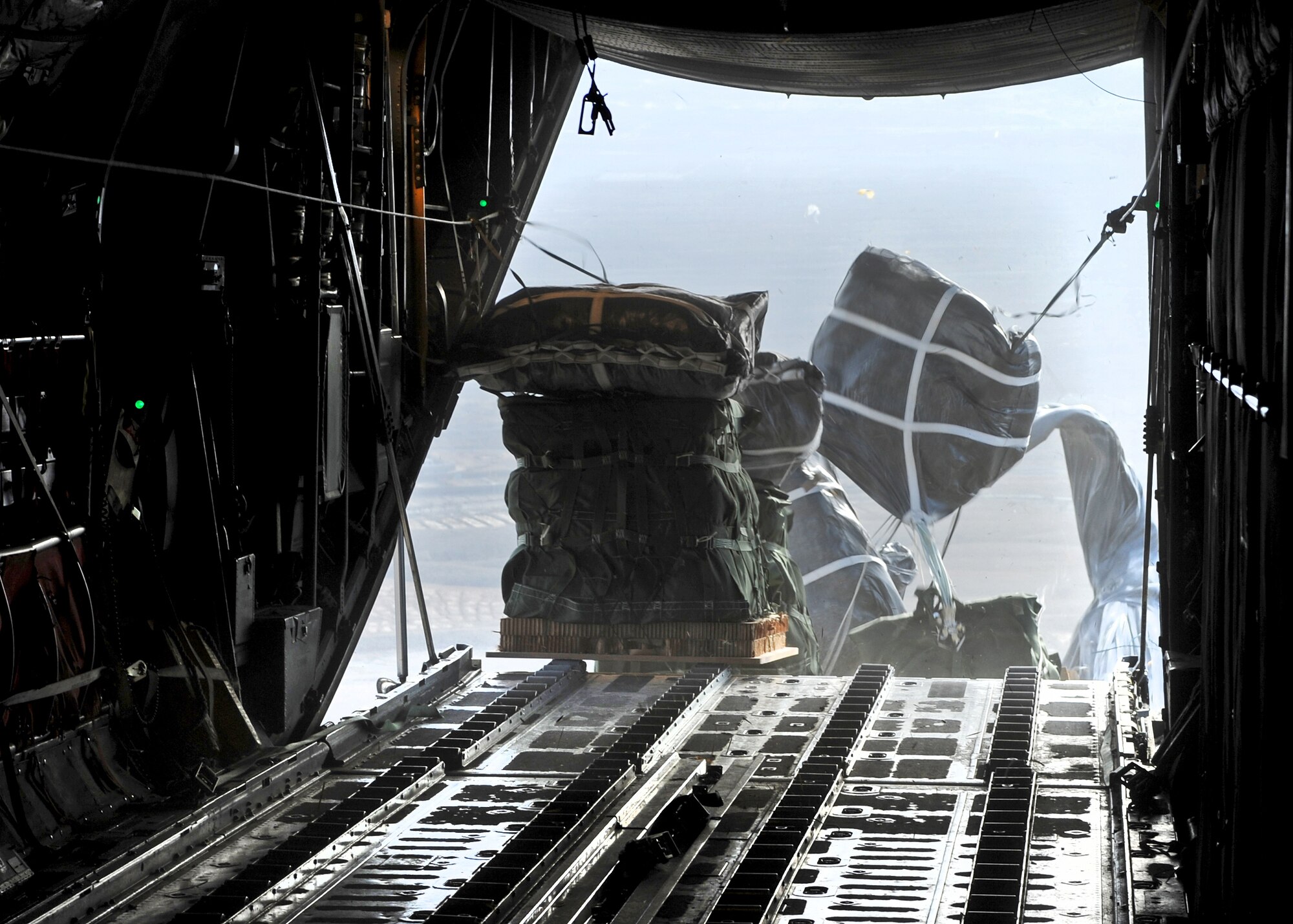 SOUTHWEST ASIA -- Supplies are dropped to ground forces in Afghanistan from the back of a C-130 Hercules during a Nov. 21, 2010, mission performed by the 737th Expeditionary Airlift Squadron. The event validated the unit's ability to perform airdrop missions in support of Operation Enduring Freedom. (U.S. Air Force photo by Lt. Col. Ken Gjone)