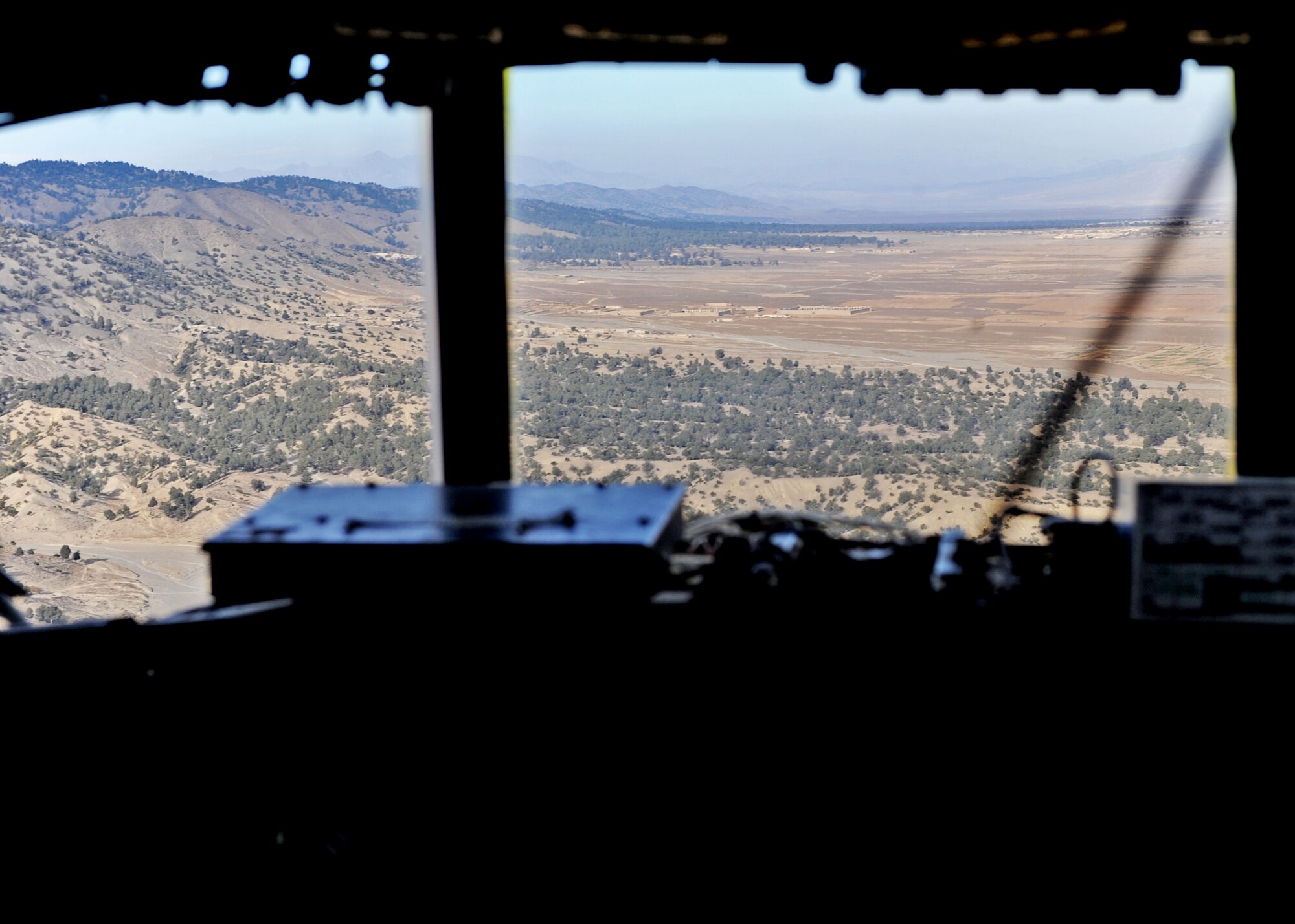 SOUTHWEST ASIA -- An aerial view of Afghanistan can be seen from the cockpit of a C-130 Hercules assigned to the 386th Air Expeditionary Wing. U.S. forces serving on the front lines often receive supplies via ground transport, but airdropping can be a safer option because of the number of Improvised Explosive Devices along supply routes. On Nov. 21, 2010, the wing's 737th Expeditionary Airlift Squadron performed its first airdrop mission into Afghanistan since the wing stood up more than 10 years ago. (U.S. Air Force photo by Lt. Col. Ken Gjone)