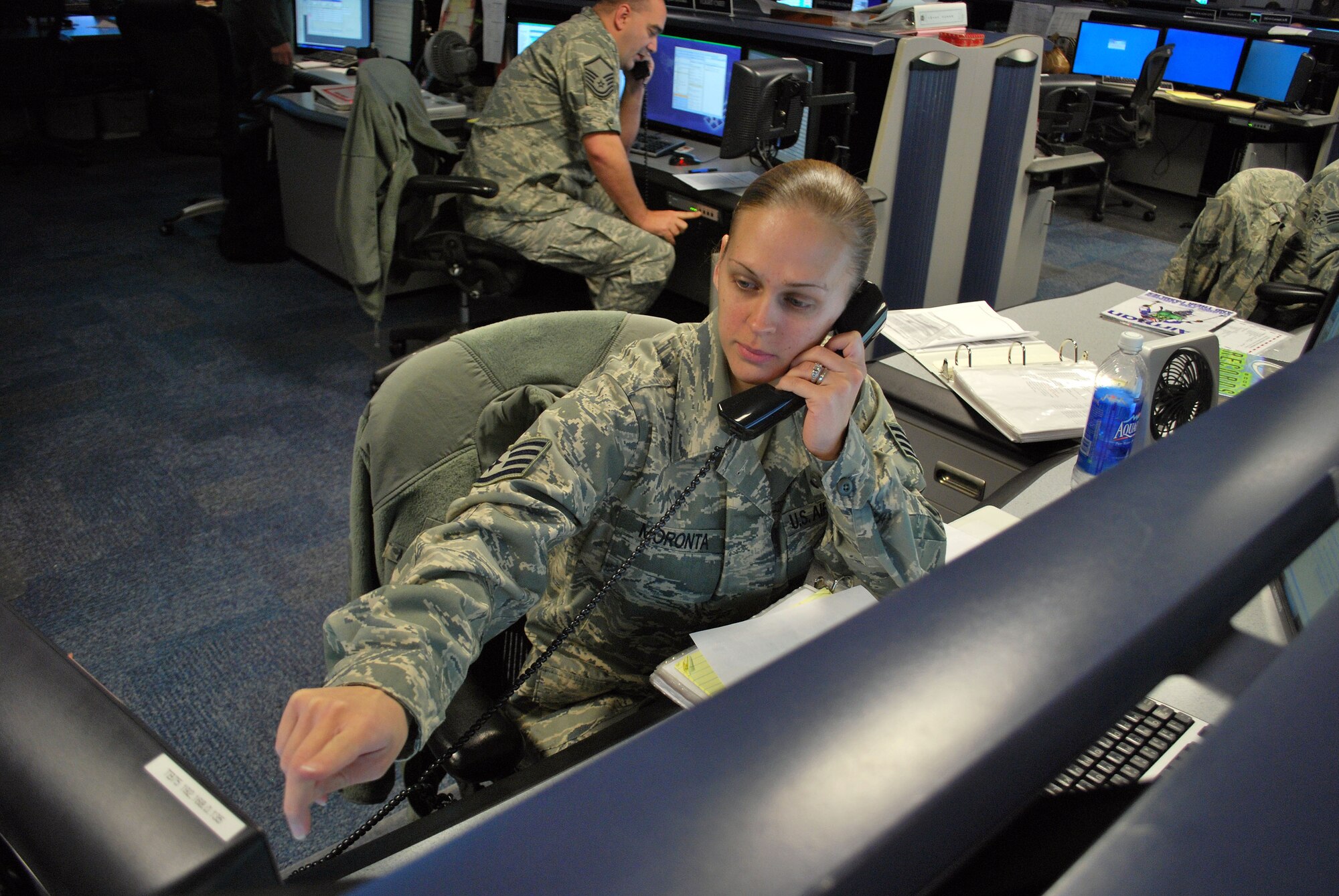 Then-Staff Sgt. Crystal Moronta, a command post controller for the 618th Air and Space Operations Center, coordinates an Air Mobility Command airlift mission from the 618th AOC's operations floor at Scott AFB, Ill., in this file photo.  Sergeant Moronta was promoted to technical sergeant on Dec. 4, by Brig. Gen. Sam Cox, the 618th AOC commander, under the Stripes for Exceptional Performers program.  (U.S. Air Force photo/Capt. Justin Brockhoff)