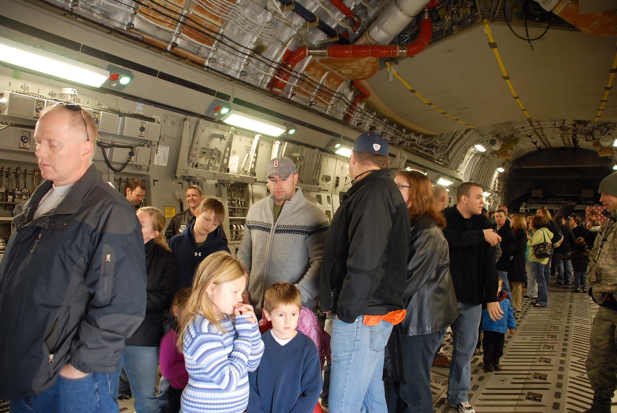 Members from Dover Air Force Base, Del., stand in line to have their pictures taken with Santa Claus on a C-17 Globemaster III Dec. 5, 2010. The event was sponsored by the Dover AFB Airman & Family Readiness Center for its second year.  (U.S. Air Force photo by Airman 1st Class Matthew Hubby/Released) 