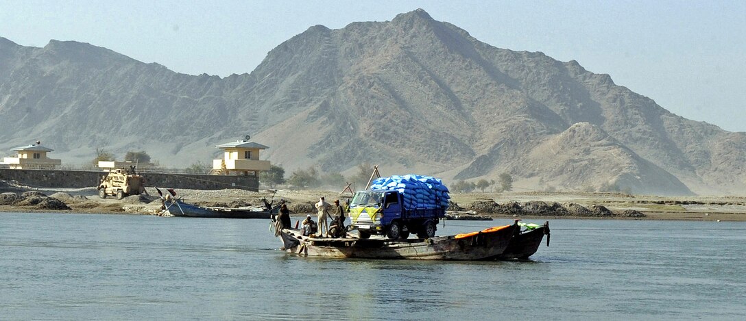 Local residents ride a ferry across the Kabul River in Afghanistan, Dec. 6, 2010. U.S. Marines are constructing a bridge to improve the quality of life for Afghans of the Kama, Ghosta and Lal Pur villages.