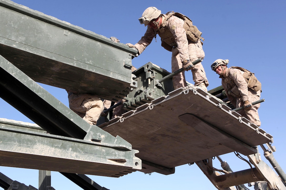 U.S. Marines with the 8th Engineer Support Battalion, 1st Marine Logistics Group (Forward), use a forklift during a bridge construction mission in Helmand province’s Sangin district, Afghanistan, Dec. 9, 2010. 