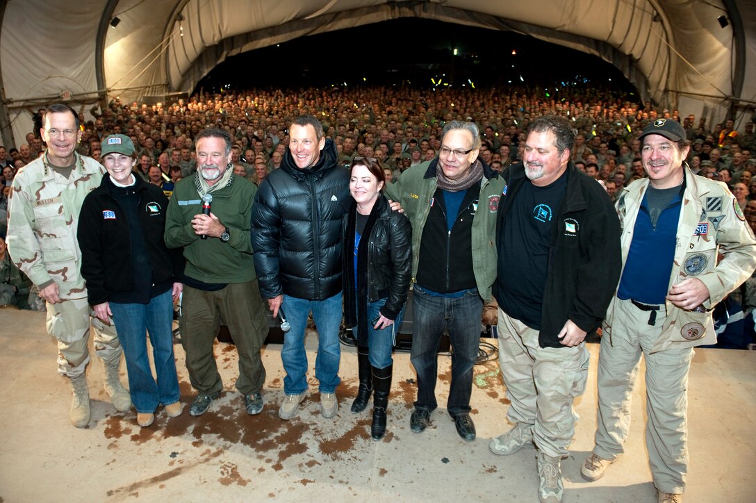 U.S. Navy Adm. Mike Mullen, chairman of the Joint Chiefs of Staff, Deborah Mullen, Robin Williams, Lance Armstrong, Kathleen Madigan, Lewis Black, Bob Dipiero and Kix Brooks pose for photos after the USO Holiday Tour show at Bagram Air Field, Afghanistan, Dec.15, 2010. 