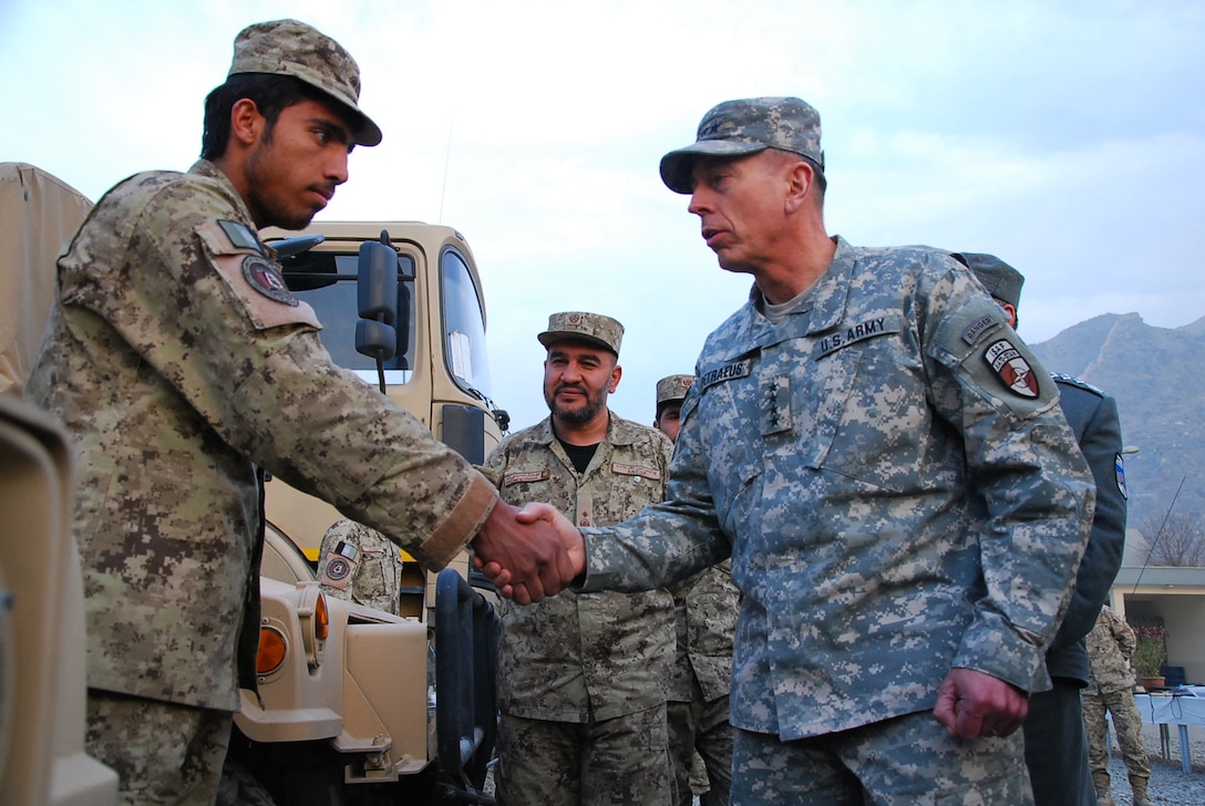 U.S. Army Gen. David Petraeus, commander of NATO’s International Security Assistance Force, shakes the hand of an Afghan National Civil Order Police patrolman in Kabul, Afghanistan, Dec. 14, 2010. Petraeus visited leaders there at the conclusion of the order's three-day leadership seminar. 