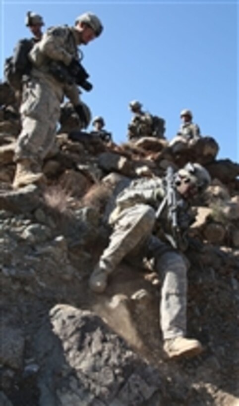 U.S. Army soldiers with Headquarters and Headquarters Company, 2nd Battalion, 327th Infantry Regiment negotiate the terrain as they head toward their destination during Operation Eagle Claw II in eastern Afghanistan's Kunar province on Dec. 10, 2010.  Eleven insurgents were killed during the two-day operation.  